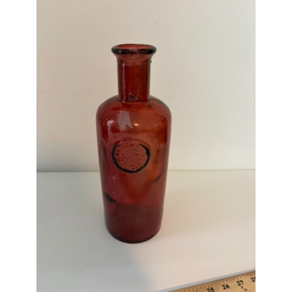 vtg ruby red glass bottle with circular medallion